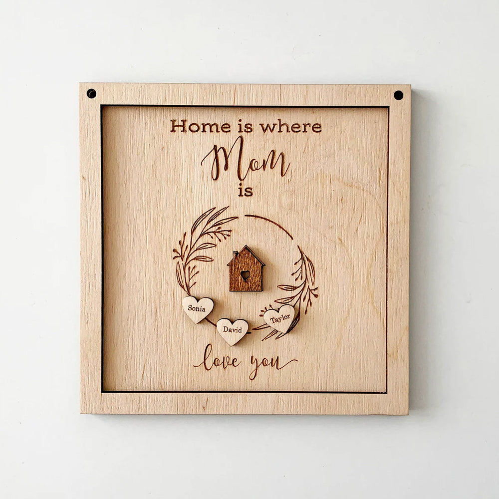 Фронтален изглед на декоративна табела пано с гравиран текст "Home is where Mom is" и персонализирани имена 